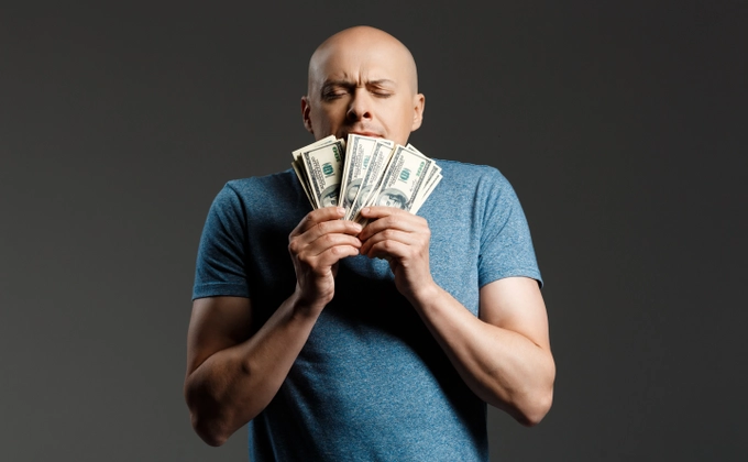 A man obsessed with money in his hands