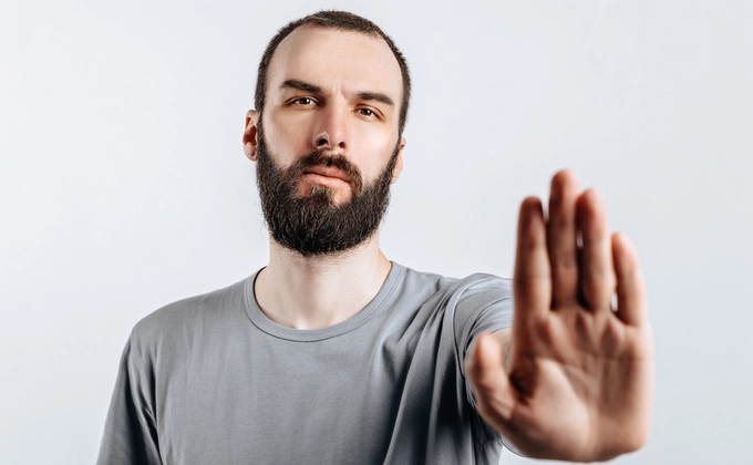 man holding hands out saying stop