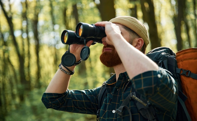 man using binoculars