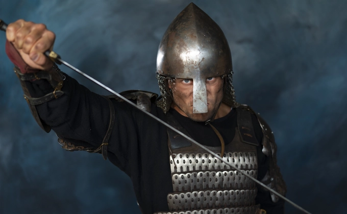 A medieval soldier posing defensively with a sword