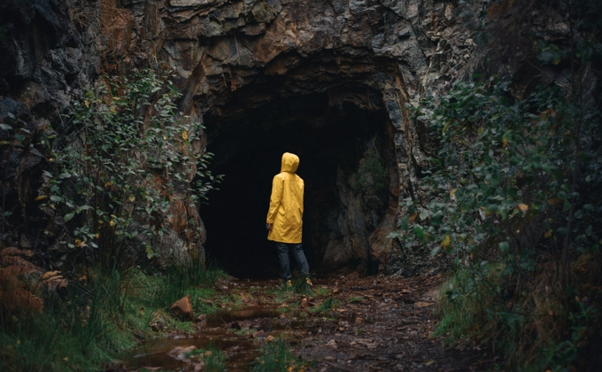 A person entering a cave