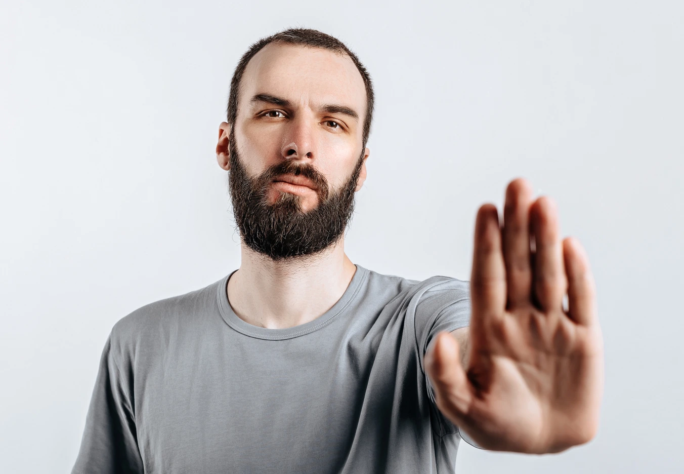 man holding hands out saying stop