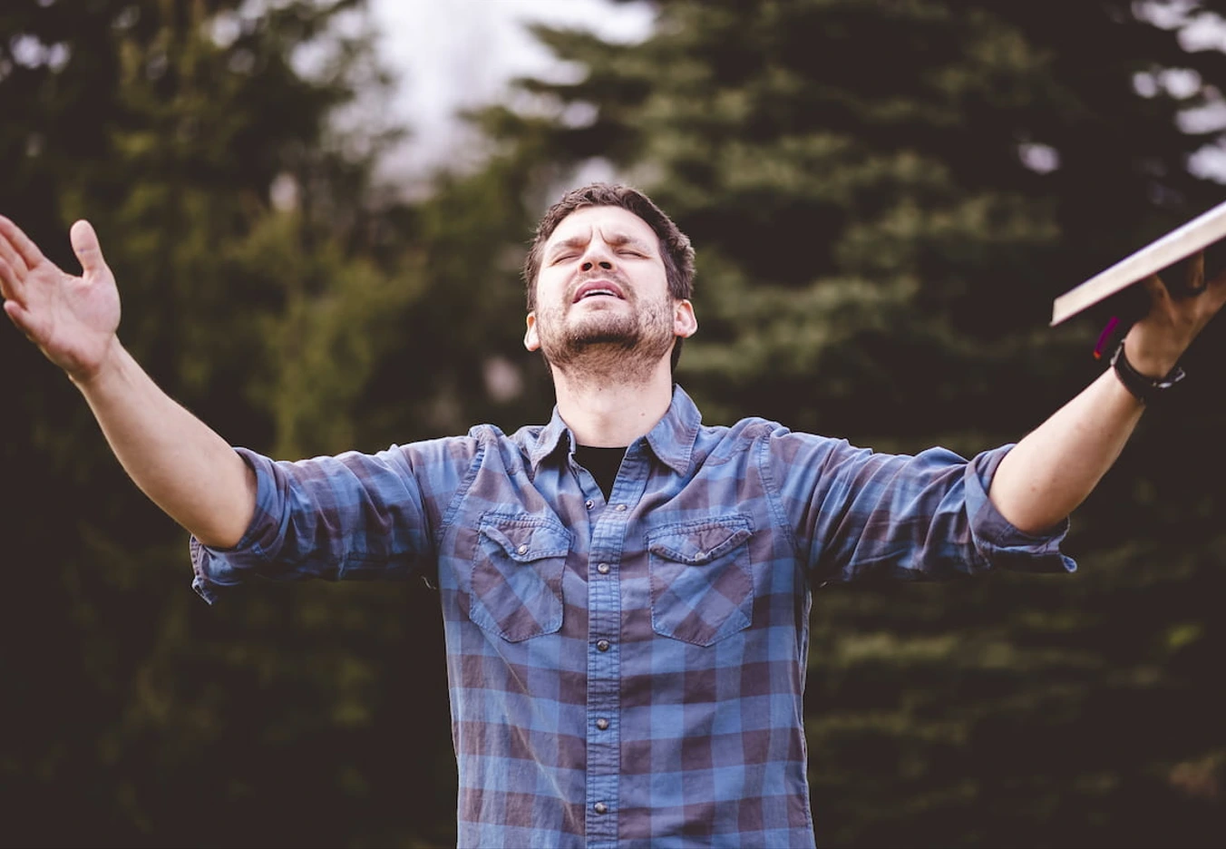 man with hands lifted up