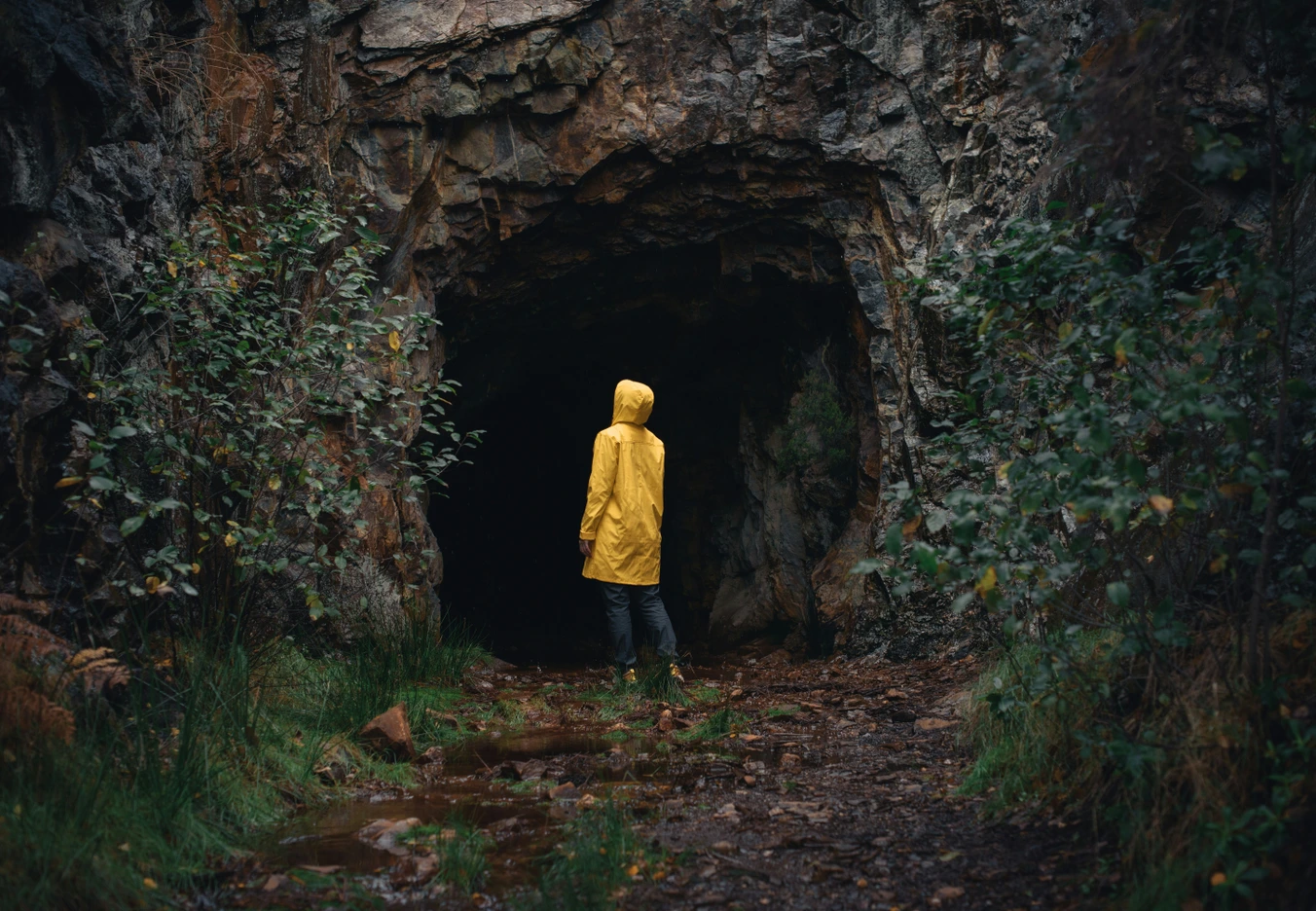 A person entering a cave